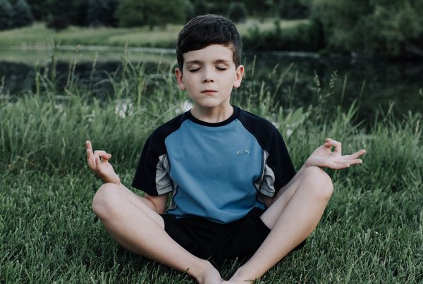 Photo of Child Meditating with Legs Crossed